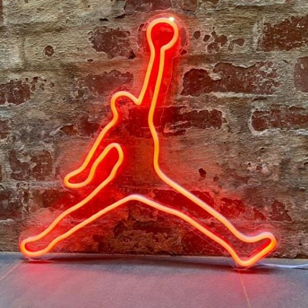 Basketball player neon art in red LED neon flex shown against a brick wall - from Custom Neon®