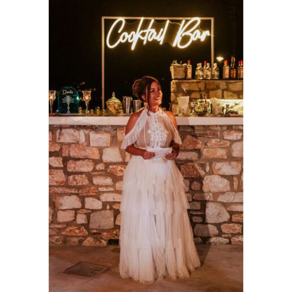Cocktail Bar Neon Sign shown behind the bar at a wedding - photo from CustomNeon.com