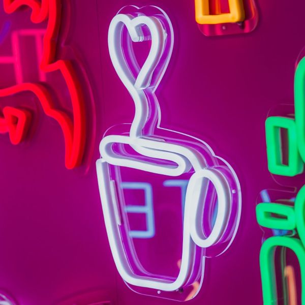 Custom Neon® Coffee Cup with Heart Line Art shown illuminated against a dark background in low light