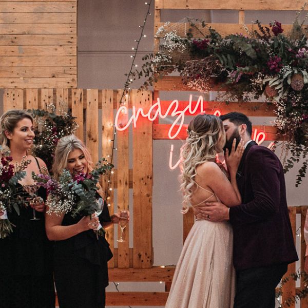 Crazy in Love LED neon wedding sign on a wooden/floral  background for wedding photo shoots - photo from Custom Neon
