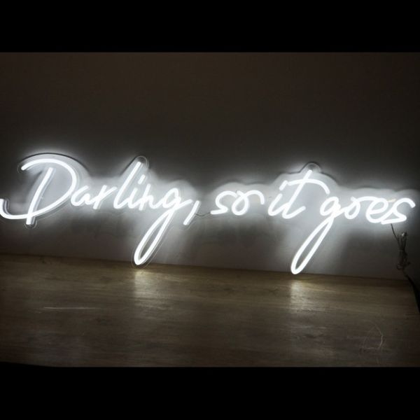 Darling, so it goes LED neon flex sign shown on a wooden table - photo from CustomNeon.com