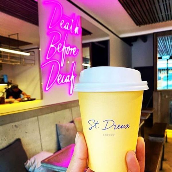 Death Before Decaf pink lightup sign on cafe wall @skullandrosecafe by Custom Neon