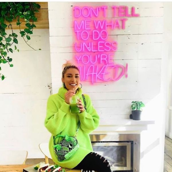 Don't Tell Me What to do Unless You're Naked neon sign in a cafe - from Custom Neon
