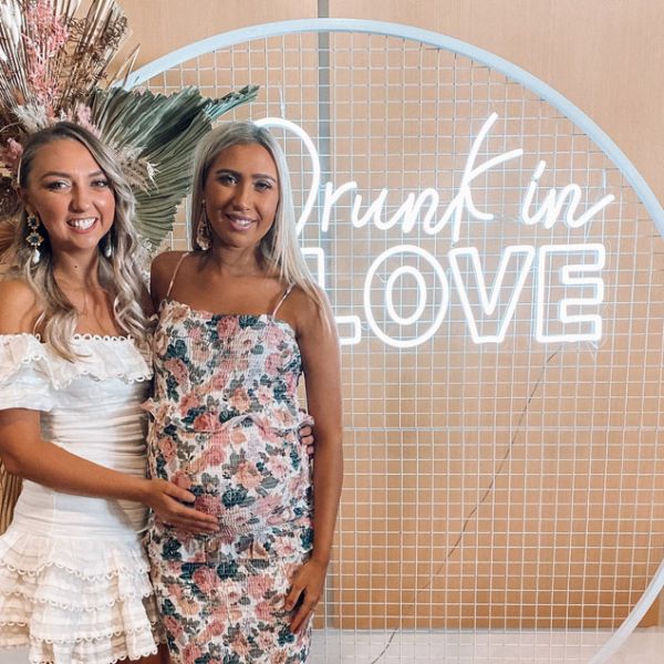Drunk in LOVE LED neon sign shown on a mesh screen as the photo wall at an event - Custom Neon