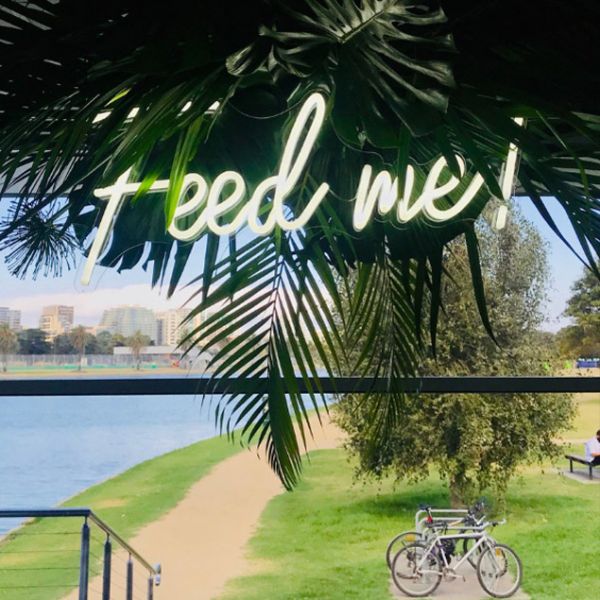 Feed Me neon sign shown in white attached to - from CustomNeon.com
