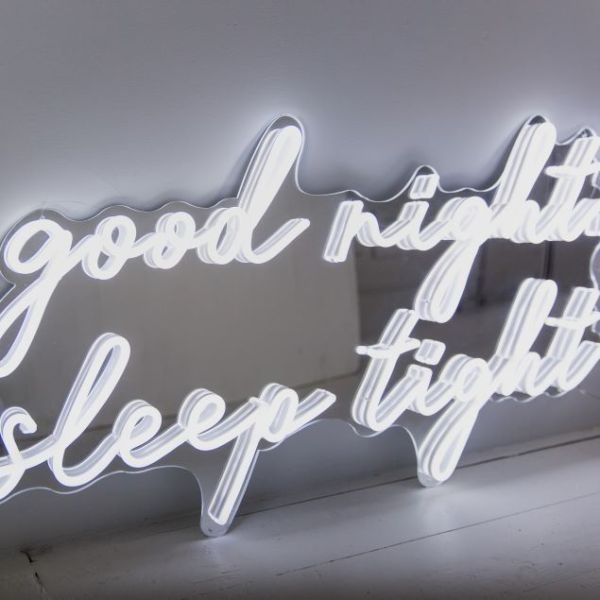 Good Night Sleep Tight white LED on silver mirrored backing shown in slightly dim light - CUSTOM NEON® 