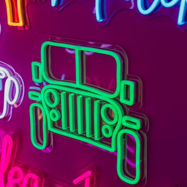 CUSTOM NEON® Garage Signs: Green Jeep LED wall art shown illuminated against a dark background in dim light