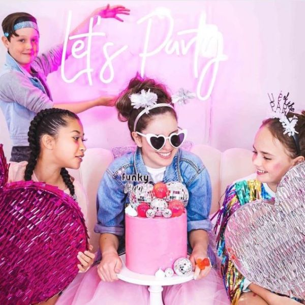 Let's Party LED neon sign shown at a tweens birthday party  - from Custom Neon