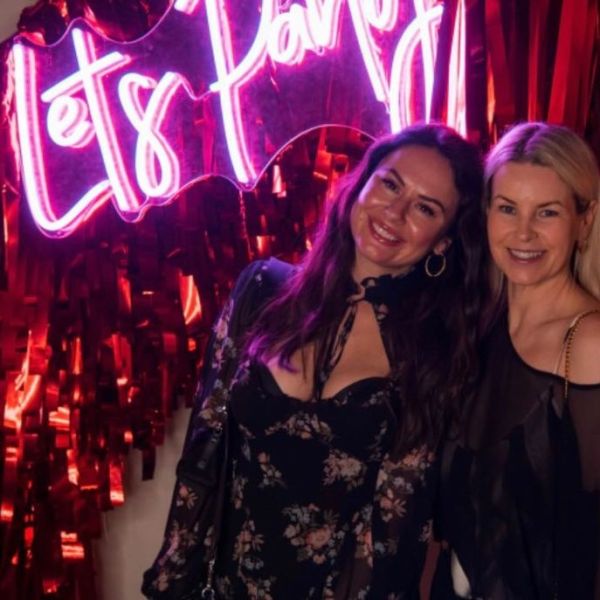 Custom Neon® hot pink Let's Party sign on red streamer wall photo booth @thewarehouse @johnhphoto