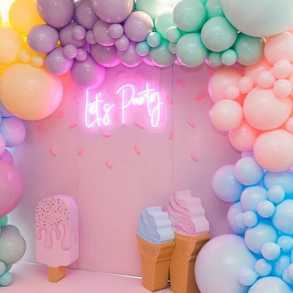 Let's Party portable LED neon sign shown on the photo wall of a kids party - photo from CustomNeon.com
