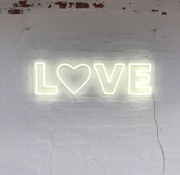 Love LED Neon Letter Light mounted on brick wall
 - photo from CustomNeon.com