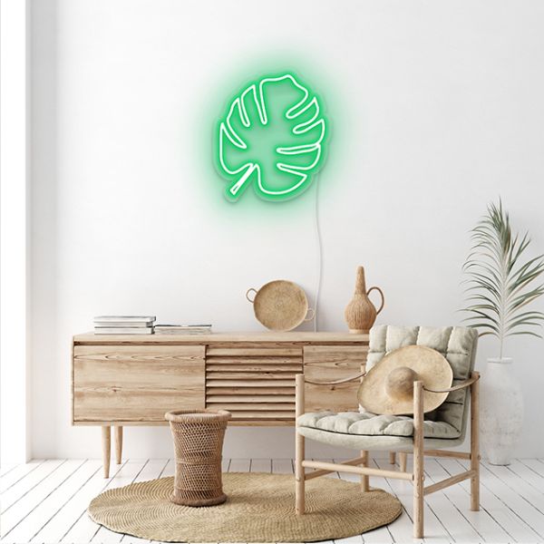 Green LED neon monstera leaf on a white wall - CUSTOM NEON®