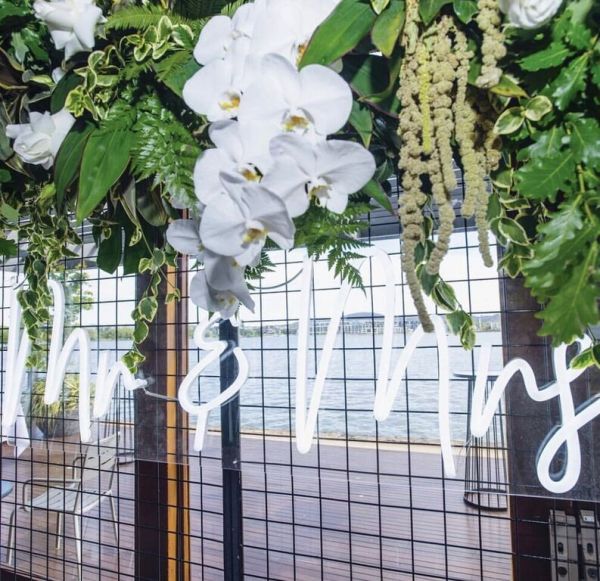 * Mr & Mrs * LED Neon Wedding Sign shown as part of the wedding decor. - Photo CustomNeon.com
