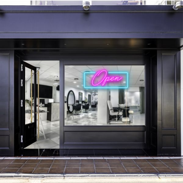 Pink open sign with a blue rectangular shown lit up on the window of a beauty salon - photo CustomNeon.com