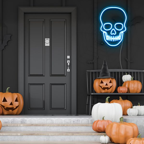 LED Neon Skull Light pre-designed light-up wall art from Custom Neon® shown on dark wall in Halloween setting