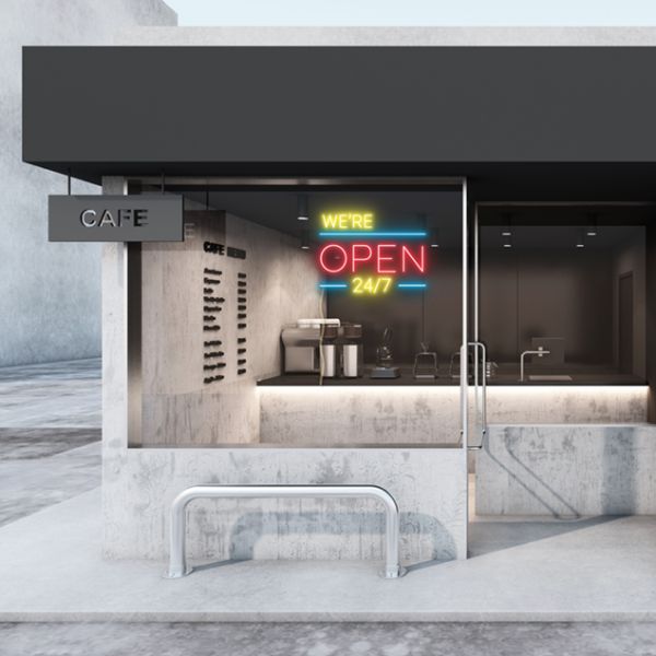 WE'RE OPEN 24/7 in brilliant yellow and red, with bright blue lines shown in a cafe window - from CustomNeon.com