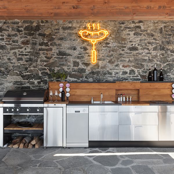 Custom Neon® BBQ sausage/hot dog sign on a brick wall above an outdoor barbecue kitchen