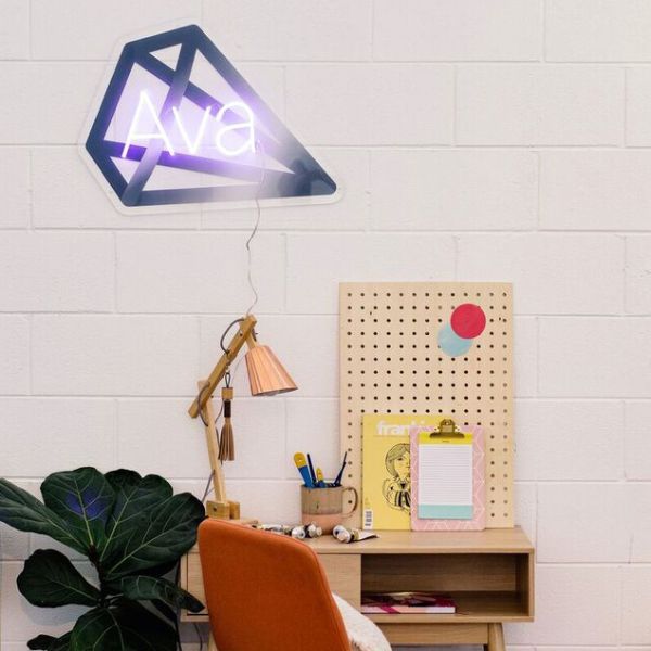 Personalized LED neon child's name sign with diamond background shown in child's bedroom- from CustomNeon.com