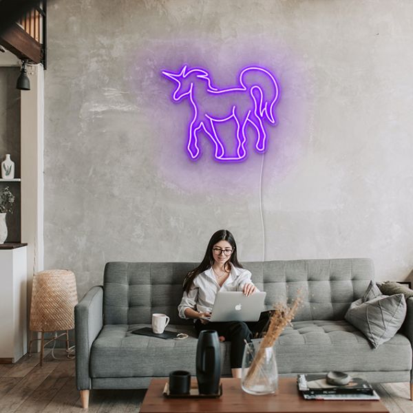Purple fantasy unicorn LED neon wall art by Custom Neon® shown on grey wall as living room décor