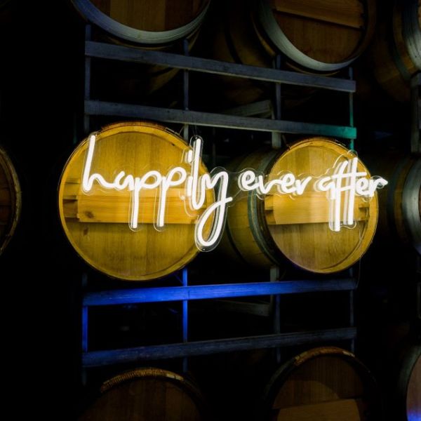 Custom Neon's Happily Ever After warm white light sign on wine barrels @SandlefordWinery photo by @louisefowlertuttphotography
