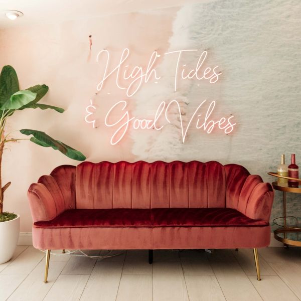 High Tides & Good Vibes pink LED neon sign installed a soft pink and blue wall mural of waves on the beach in a living room - CUSTOM NEON™ x SOMERLED COLLECTION