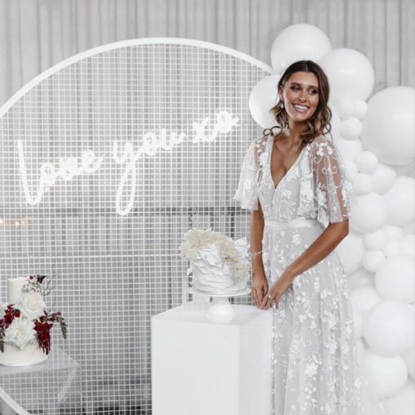 Love You XO LED neon light shown on a mesh screen with balloons, wedding cakes and the beautiful bride - by CustomNeon.com @customneon