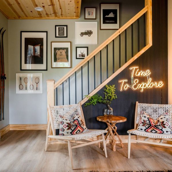 Time to Explore warm white LED neon sign on a dark wood panel wall beneath the staircase - CUSTOM NEON™ x SOMERLED COLLECTION