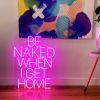 Be Naked When I Get Home LED neon sign shown on the floor beneath a painting - photo from CustomNeon.com