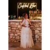Cocktail Bar Neon Sign shown behind the bar at a wedding - photo from CustomNeon.com