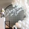 Crazy In Love Wedding Sign in brilliant LED neon flex shown in white with balloons and a wedding cake - photo from CustomNeon.com