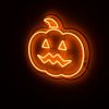 Spooky Light Up Jack O Lantern in pumpkin orange shown illuminated in a dark setting - CUSTOM NEON® Halloween Decorations