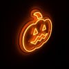 Spooky Light Up Jack O Lantern in pumpkin orange shown illuminated in a dark setting - CUSTOM NEON® Halloween Decorations