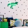 Personalized name sign in LED neon with dinosaur background shown in child's room- from CustomNeon.com