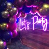 Let's Party pink LED neon light surrounded by giant balloons and party decor - from Custom Neon® @customneon