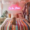 On the Moon LED neon sign wall mounted in a bedroom - made by @customneon for @malloryonthemoon