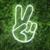 LED Neon Peace Emoji Sign Light shown on a green wall - Photo CustomNeon.com
