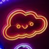 Smiley Cloud LED wall light in warm white shown illuminated against a dark background in dim light - CUSTOM NEON®