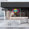 WE'RE OPEN 24/7 neon sign in yellow, blue & pink shown in a cafe window - from CustomNeon.com