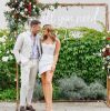 Large All You Need is Love white LED neon sign in photo booth at wedding of @georgiealove & @leeroyelliot - made by Custom NeonÂ®