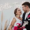 Better Together LED neon wedding sign behind the happy couple - from Custom Neon