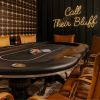 Call Their Bluff LED neon sign on a dark wooden wall behind a gaming table in a masculine room decorated in tans, blacks and browns - CUSTOM NEON™ x SOMERLED COLLECTION