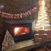 White light up Xmas tree surrounded by a modern wood fireplace, Christmas decorations & presents - by CUSTOM NEON® 