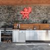 Custom Neon® BBQ Grill Sign on brick wall above an outdoor barbecue kitchen