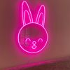 Custom Neon® pink bunny face shown as wall art in a living room