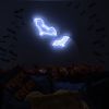 Custom Neon® Halloween bat signs shown in white LED neon wall mounted over autumn leaves.