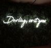 Darling, so it goes Neon Sign Quote for Weddings & Home Decor shown on green wall
 - photo from CustomNeon.com
