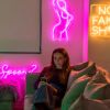 Neon flex line drawing of a nude woman in dark pink on a living room wall from Custom Neon®