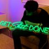 Custom Neon® green Get Shit Done wall sign shown in a bedroom setting