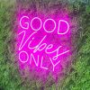 Good Vibes Only Trendy LED Neon Light in Two Fonts shown in pink on green wall from Custom Neon®