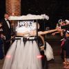 Happily Ever After portable neon sign with battery pack, shown attached to the bridal buggy - photo from CustomNeon.com